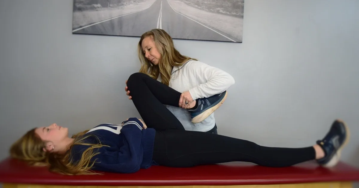 A therapist restoring knee motion during the Prime phase