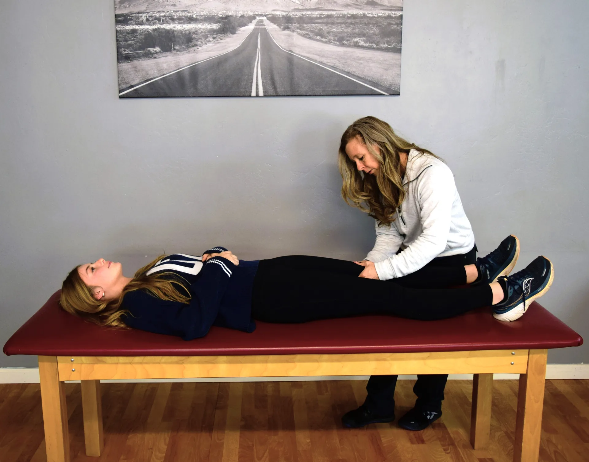 Dr. Crystal Geer performing manual therapy on a patient's lower leg
