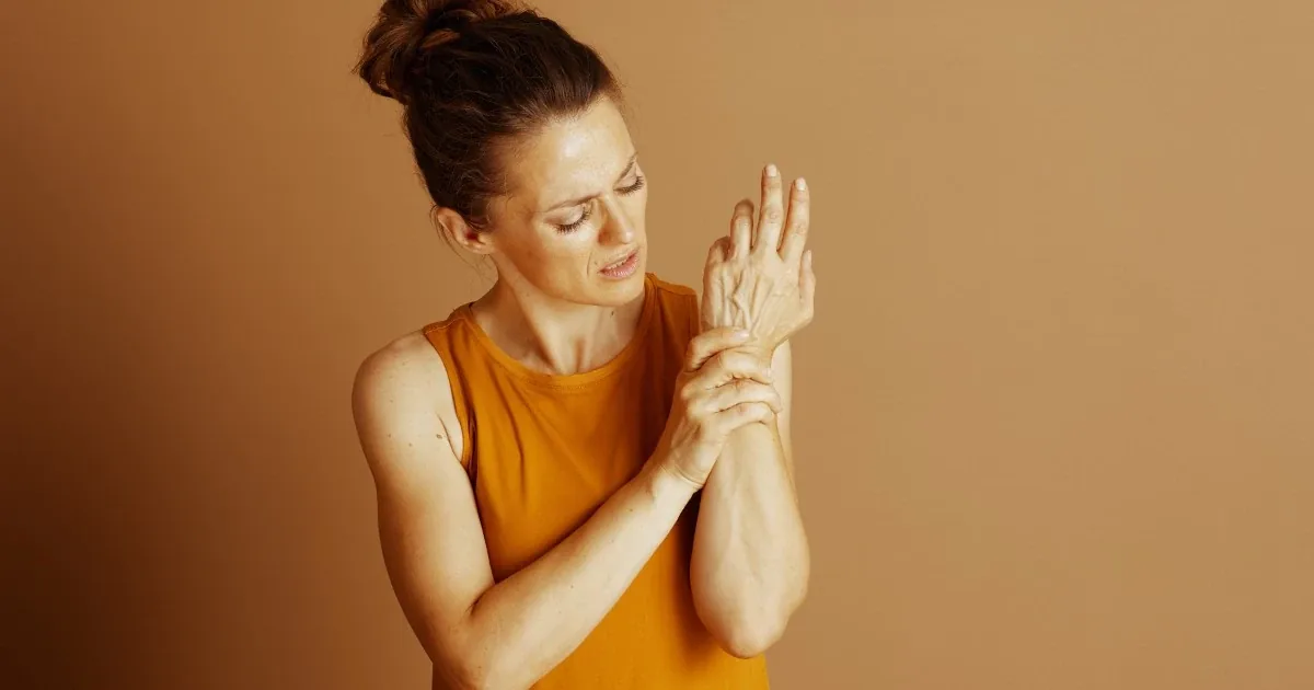 Person holding a painful wrist